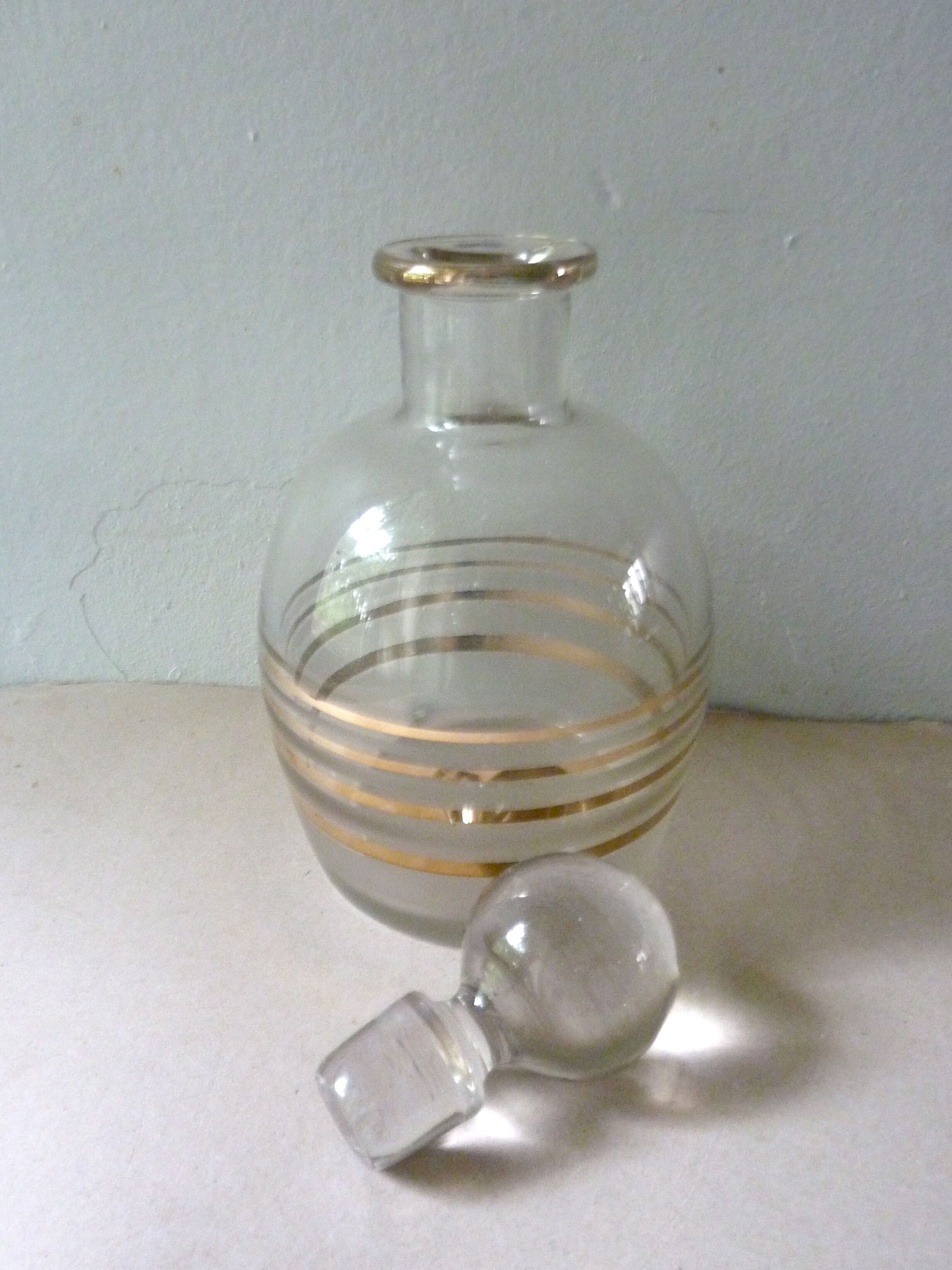 Pair of glass whiskey decanters with gold edging