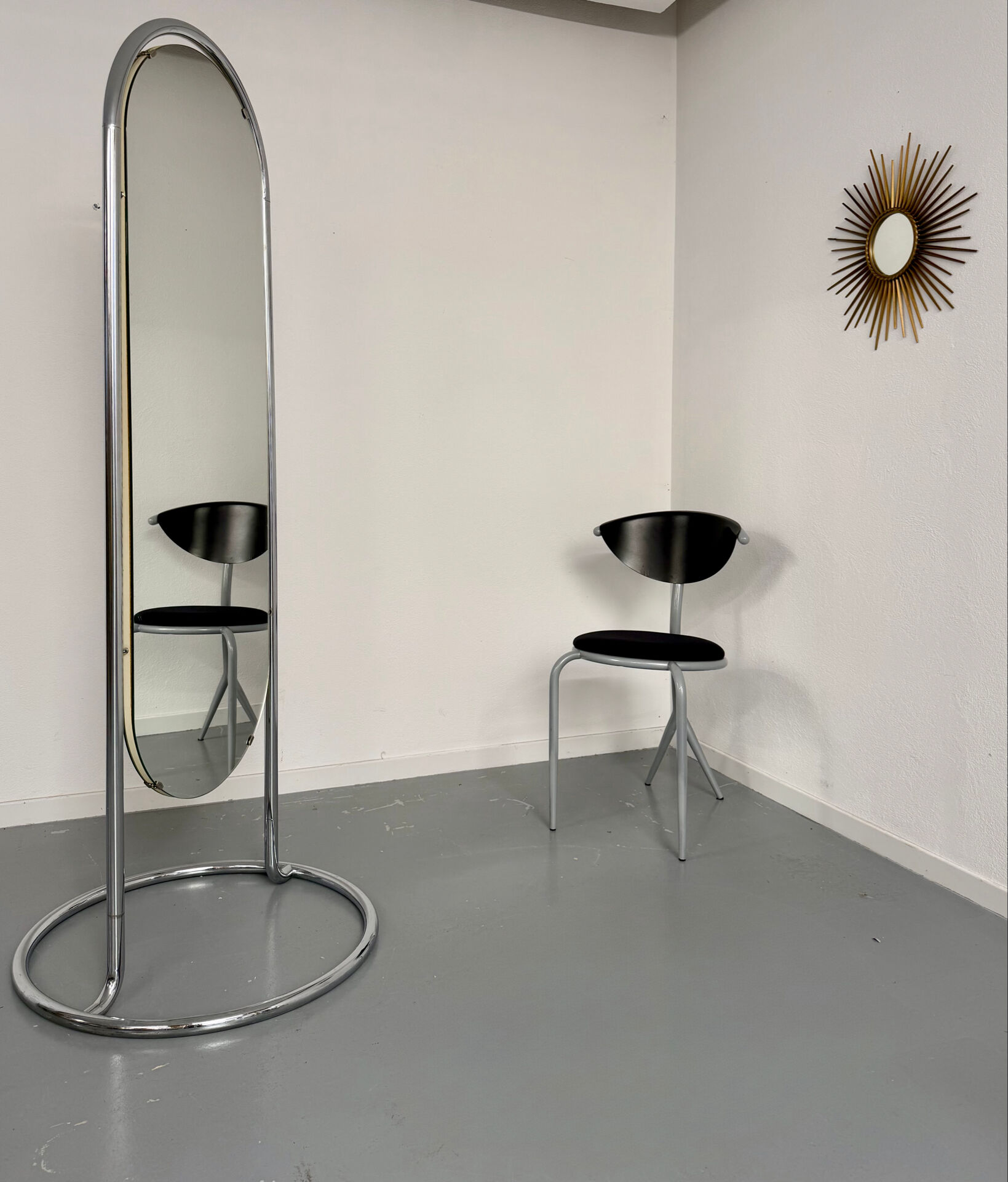 Large freestanding chrome metal full-length mirror in 1970s design.