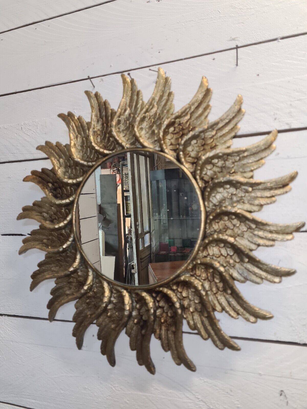 sun mirror with angel wings in golden patinated stucco