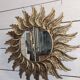sun mirror with angel wings in golden patinated stucco