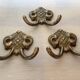 Three double brass coat hooks.