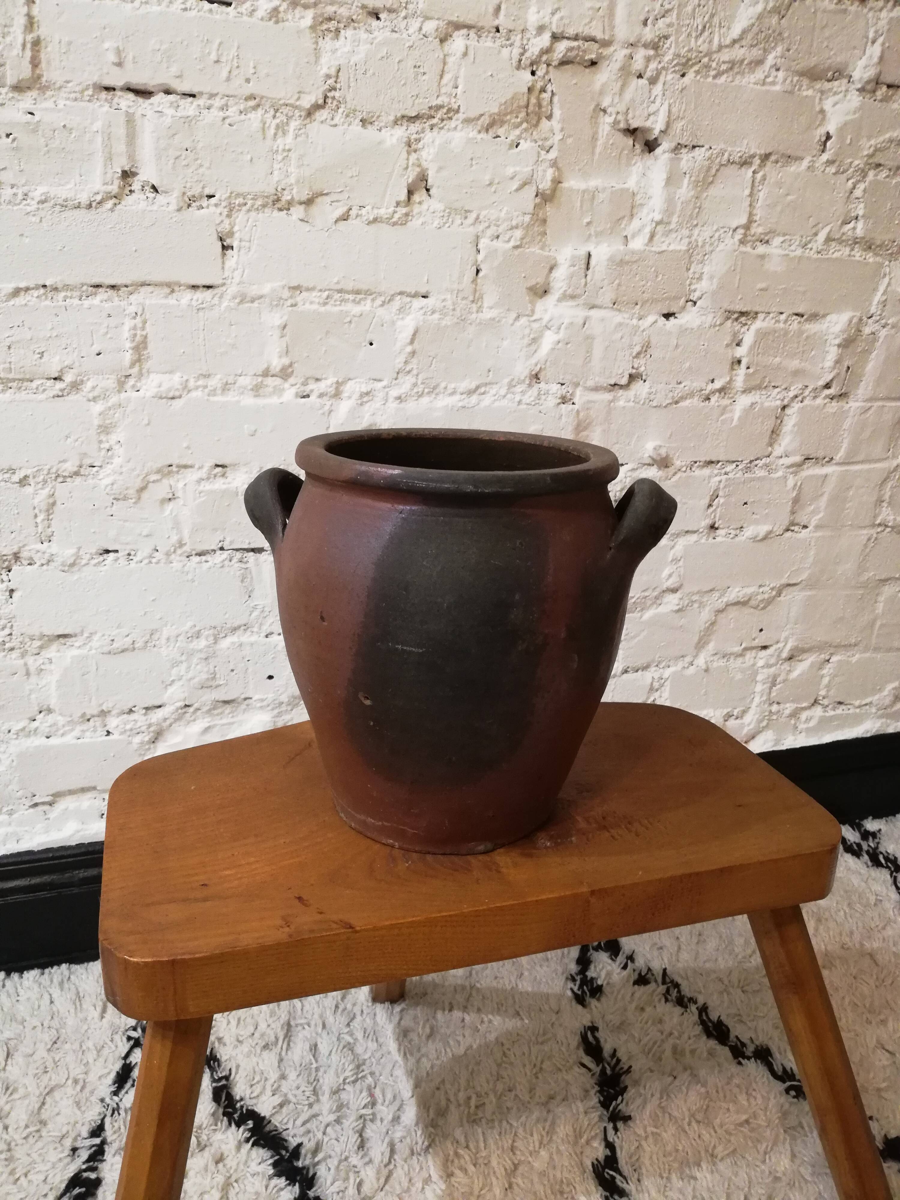 Old red and black terracotta grease pot