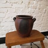 Old red and black terracotta grease pot