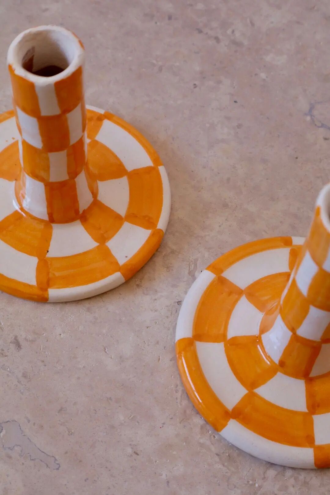 Pair of yellow and white checkered ceramic candlesticks