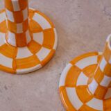 Pair of yellow and white checkered ceramic candlesticks