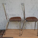 Pair of formica chairs with chrome metal backs in the shape of a lyre.