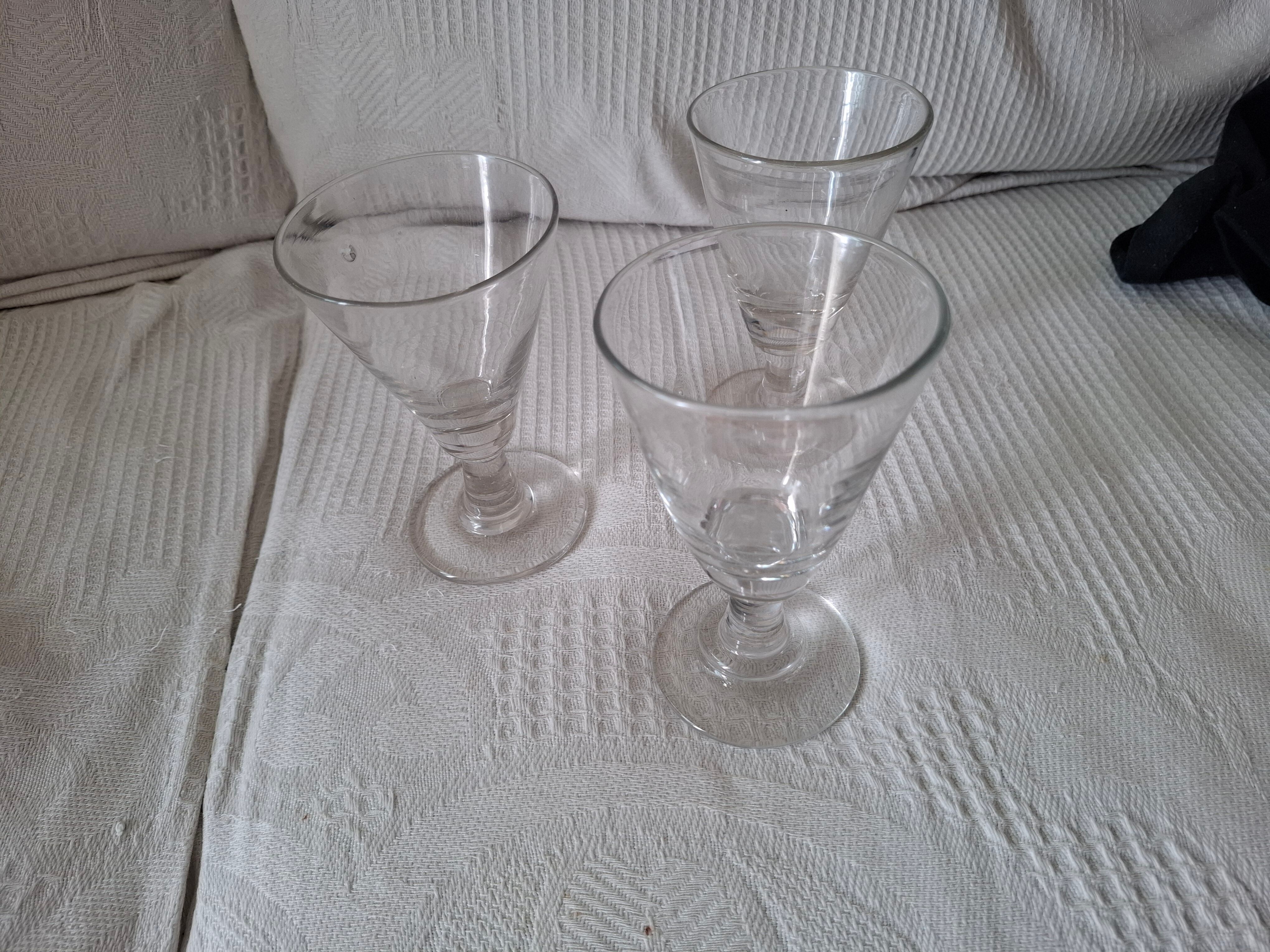 Three conical measuring glasses