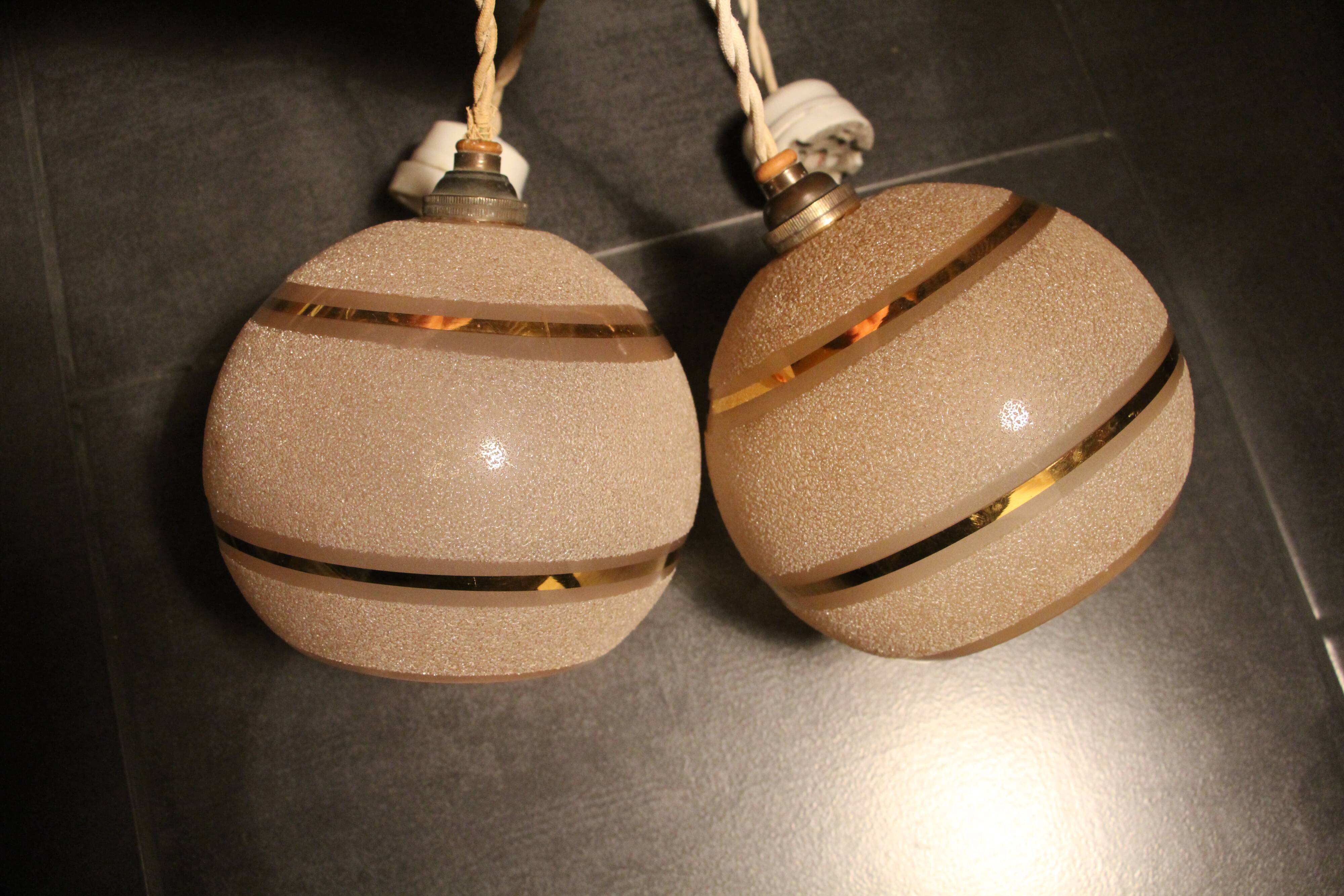 Set of two Art Deco pendant lamps in pink and gold glass