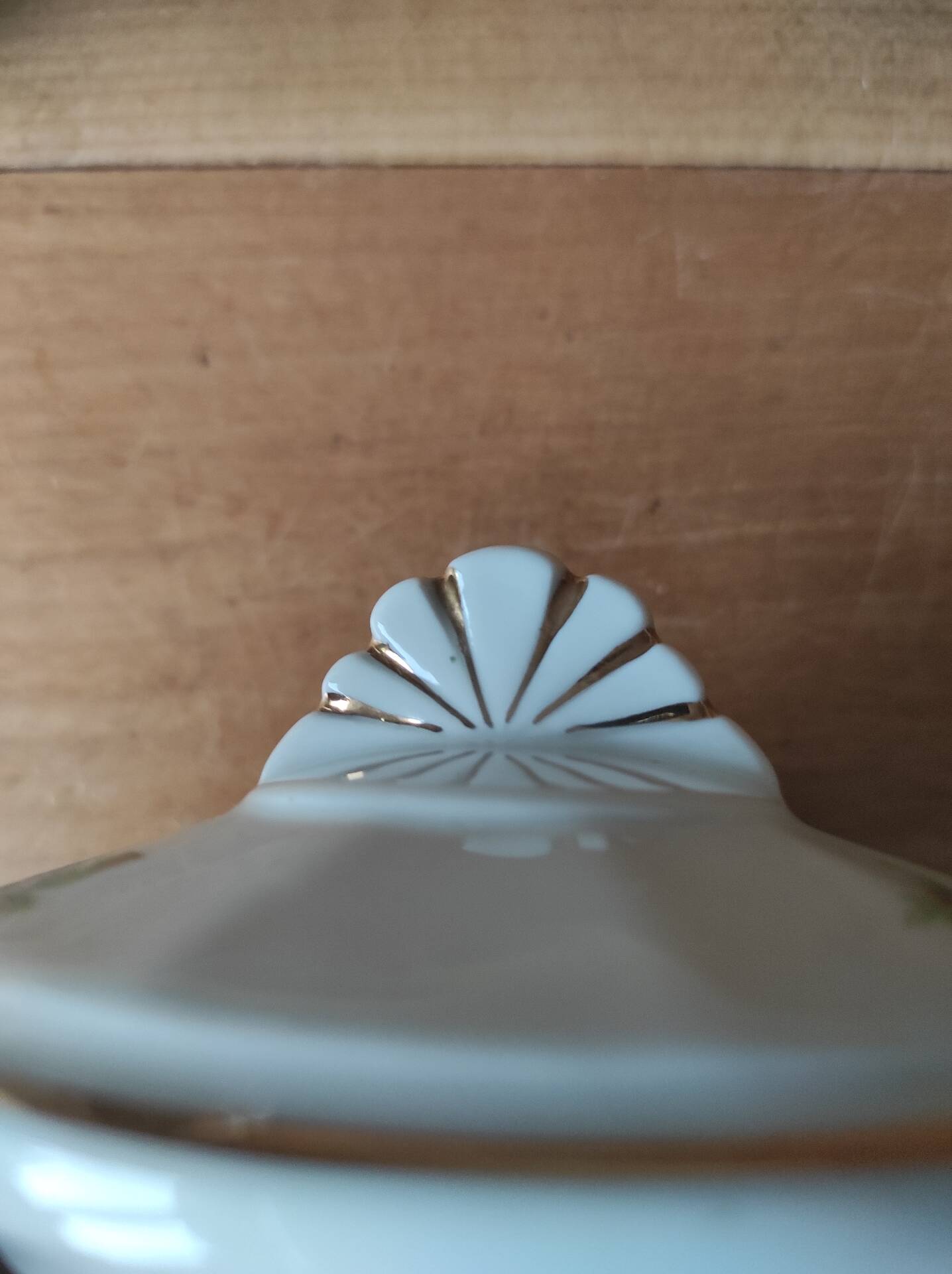 Antique porcelain sugar bowl with a decagonal base.