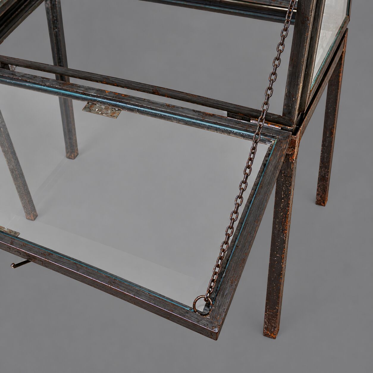 A showcase made of steel and glass, mounted on a custom-made steel base.