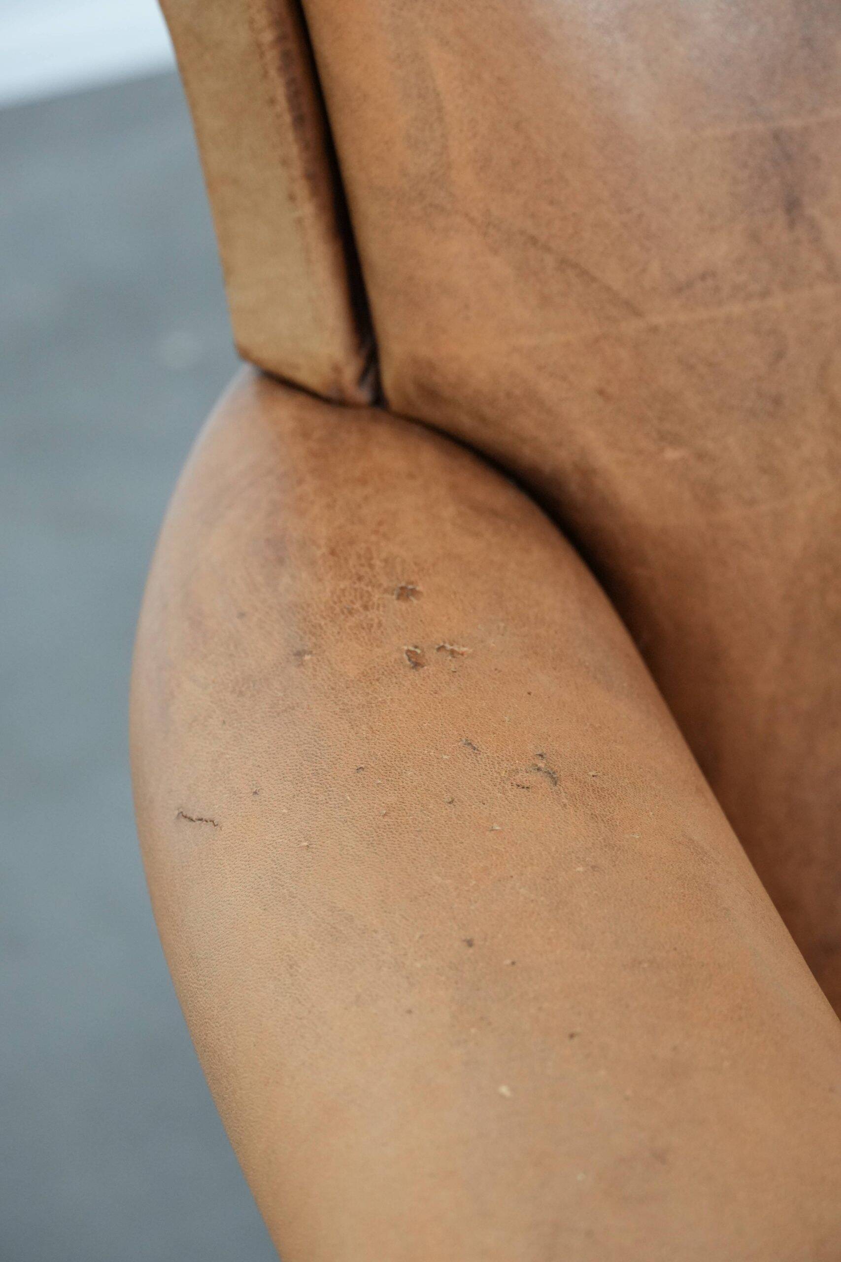Beautiful subtle vintage sheepskin armchair with elegant legs