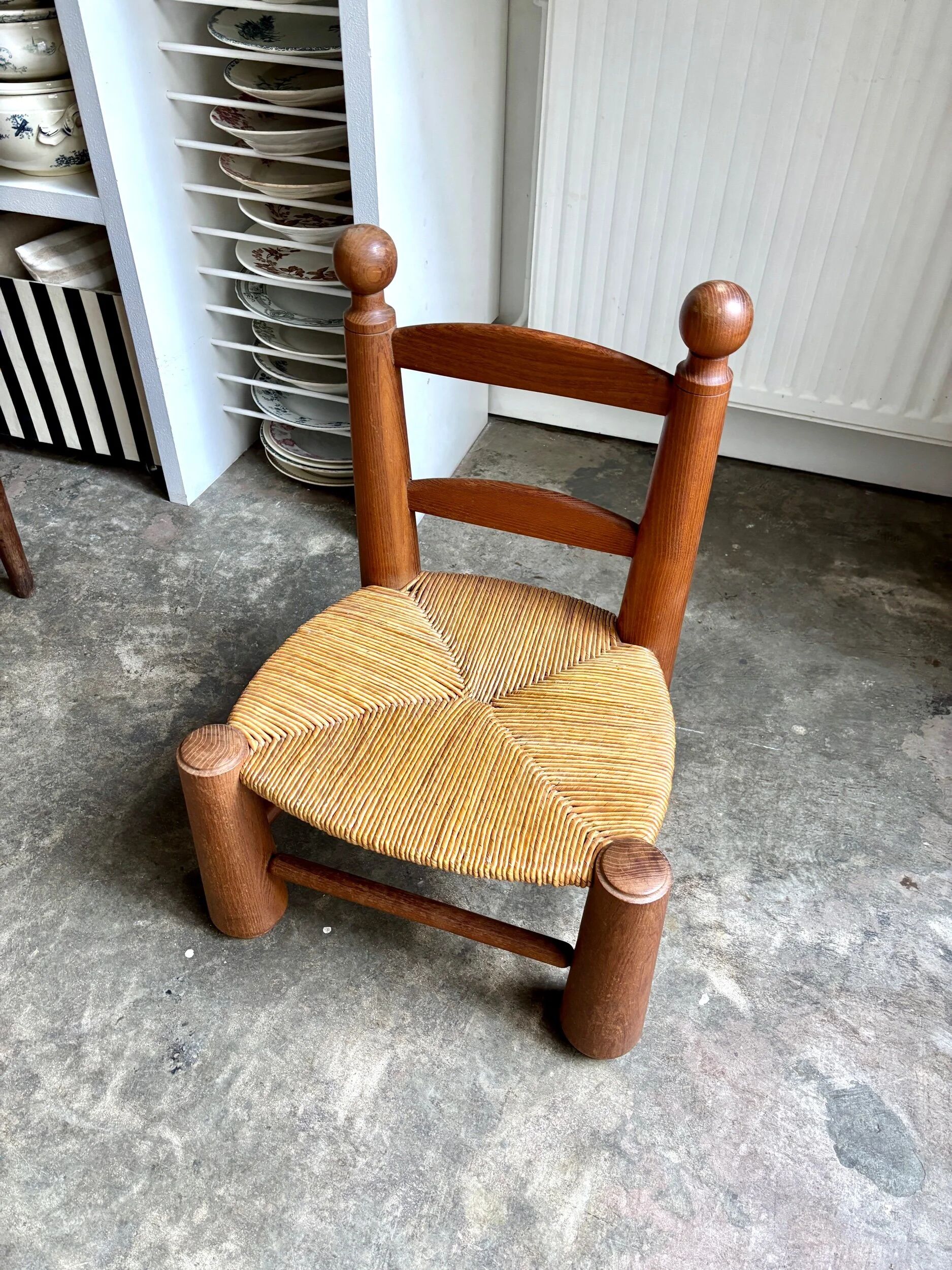 Brutalist low chair in dark wood and straw no. 3