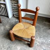 Brutalist low chair in dark wood and straw no. 3