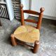 Brutalist low chair in dark wood and straw no. 3