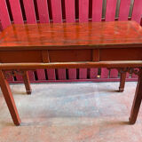 Red lacquer desk, Qing period of the XIXth century, opening to three drawers
