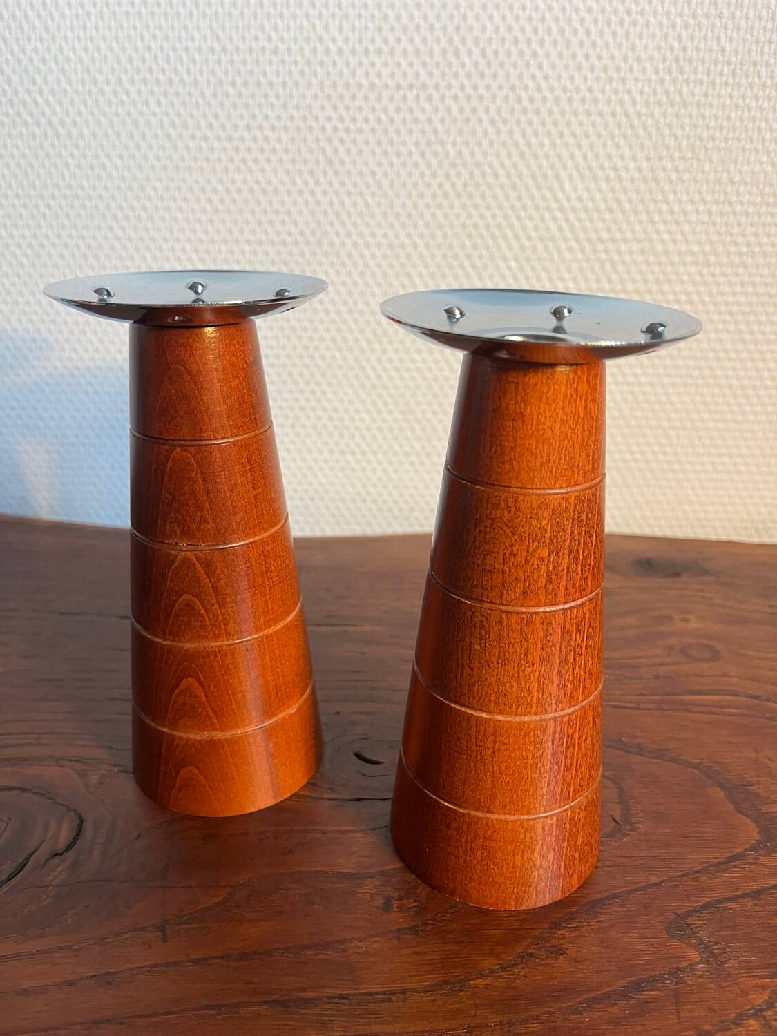 Pair of Guy Degrenne wooden and stainless steel candlesticks