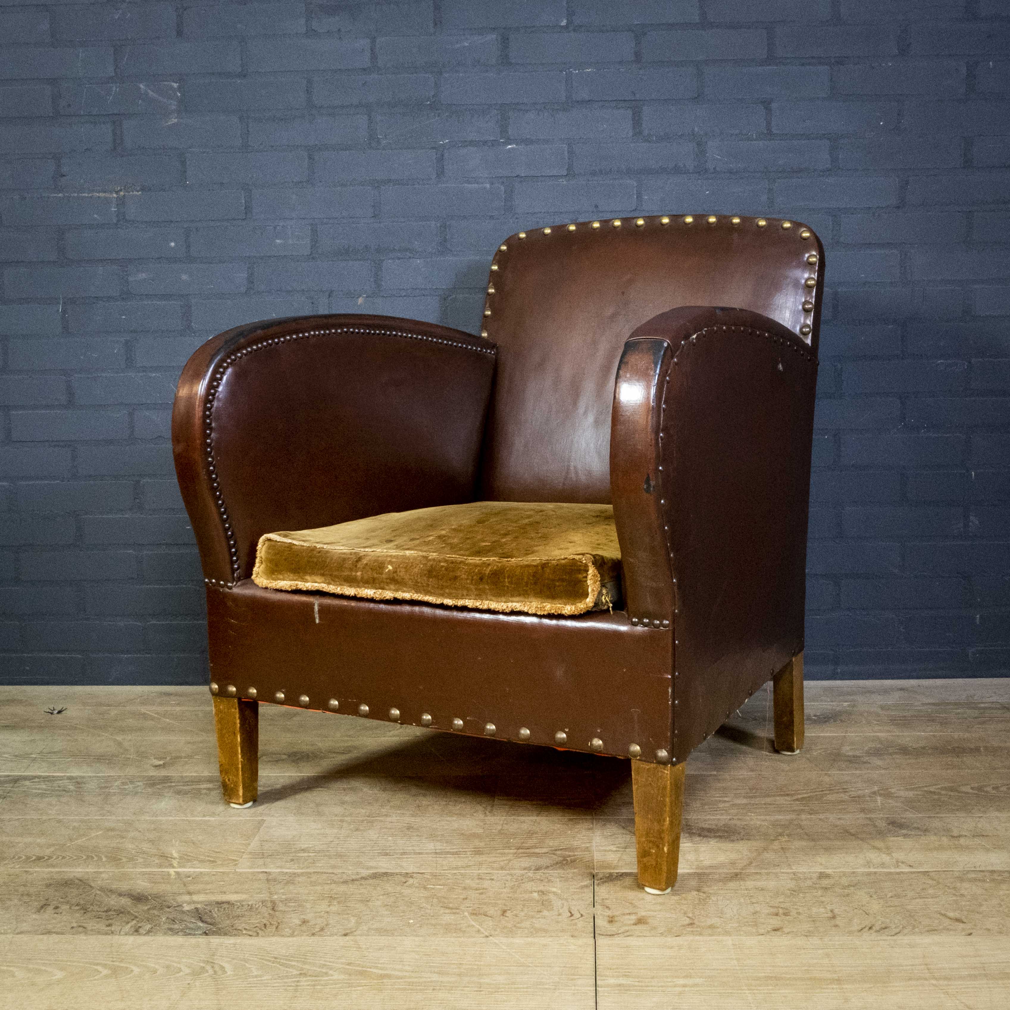 Antique club armchair of leather cloth