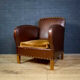 Antique club armchair of leather cloth
