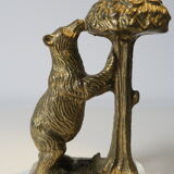 Brass sculpture, bear looking for honey in the tree