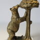 Brass sculpture, bear looking for honey in the tree