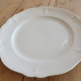 Round vintage ivory earthenware serving dish with scalloped rim.