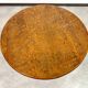 Round Art Nouveau coffee table with a sculpted top.