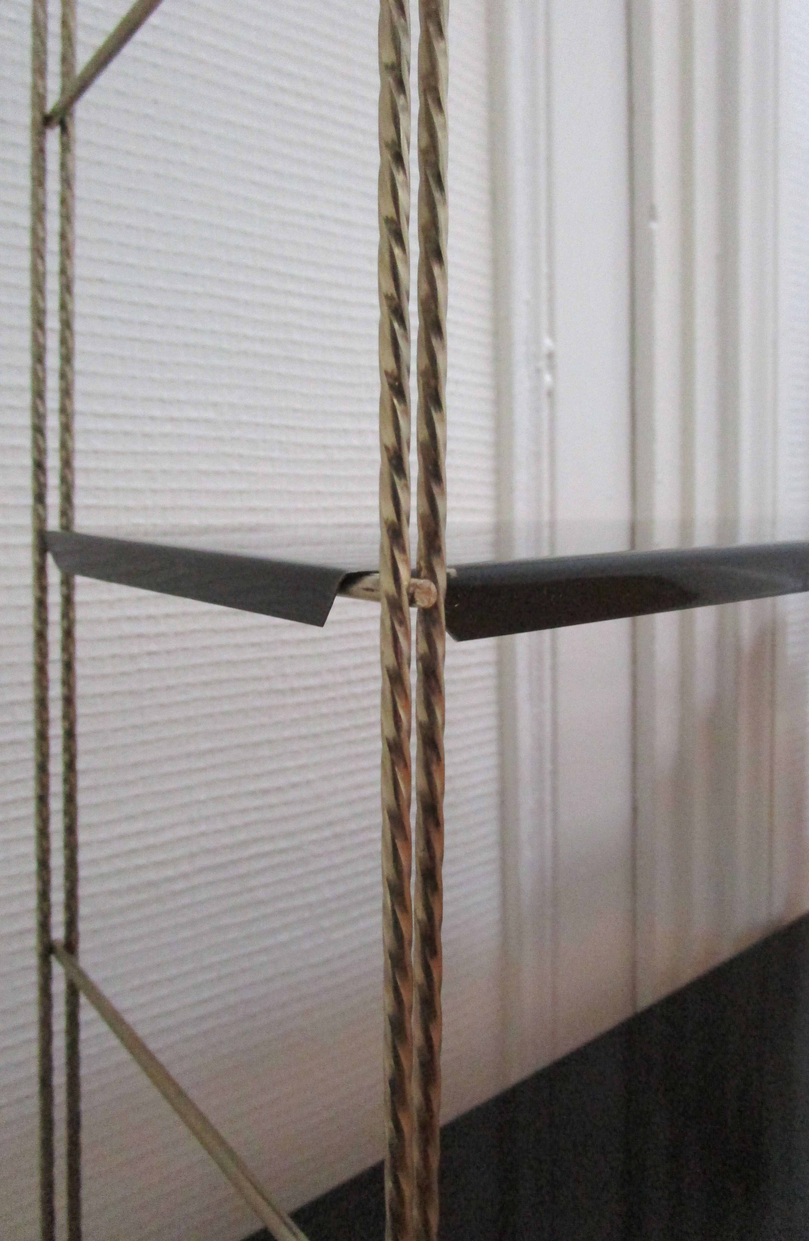 Black and gold metal tomado wall shelf