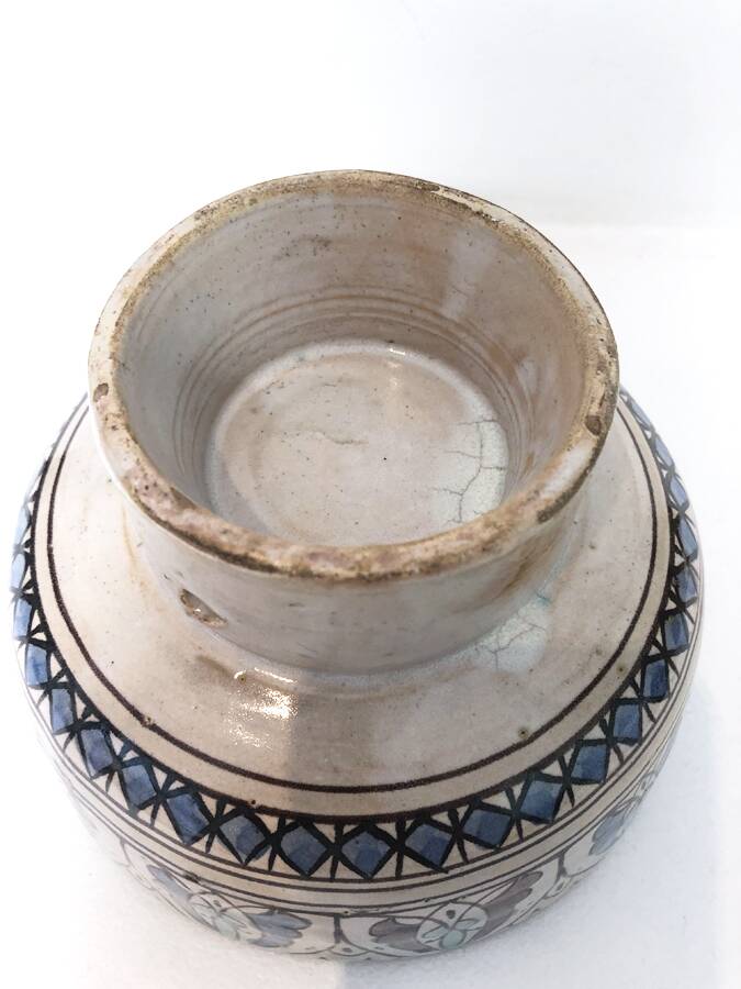 Cup on a ceramic pedestal – blue and turquoise geometric design.