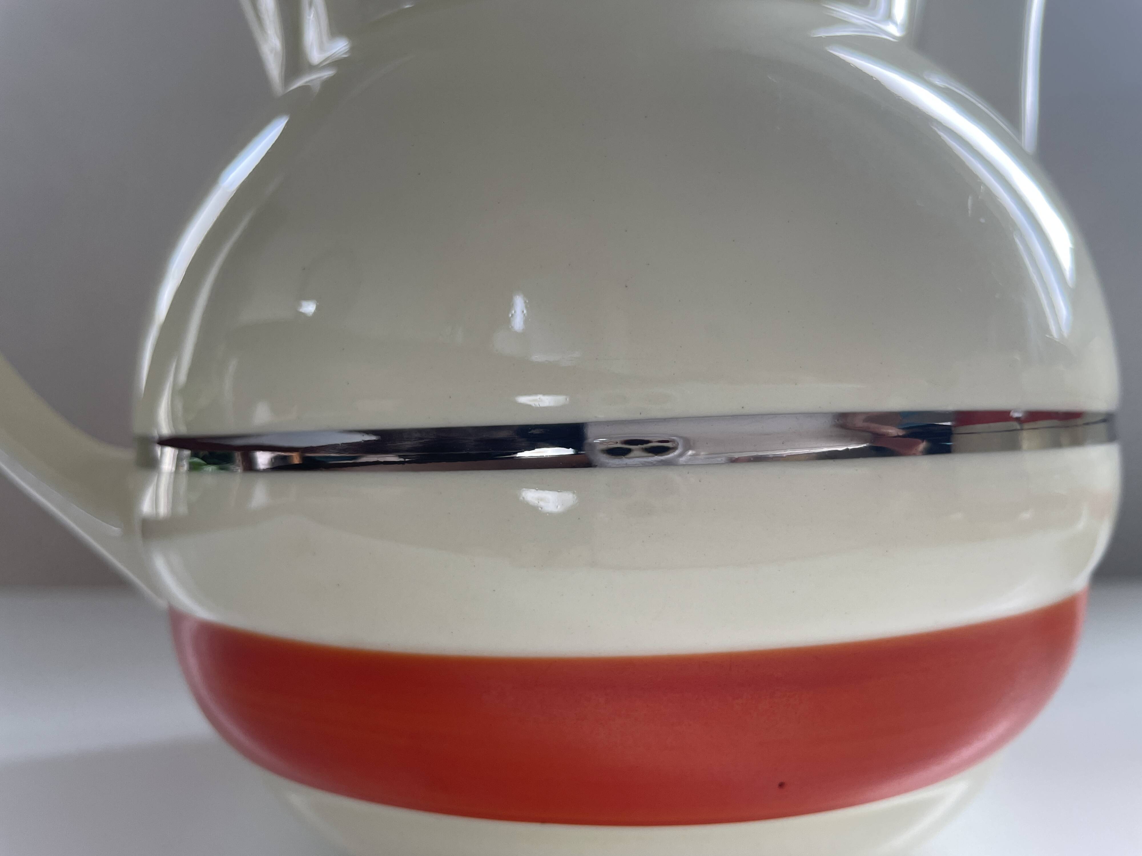 Red, white and silver porcelain jug set by Edmond Bellefroid for Robo.