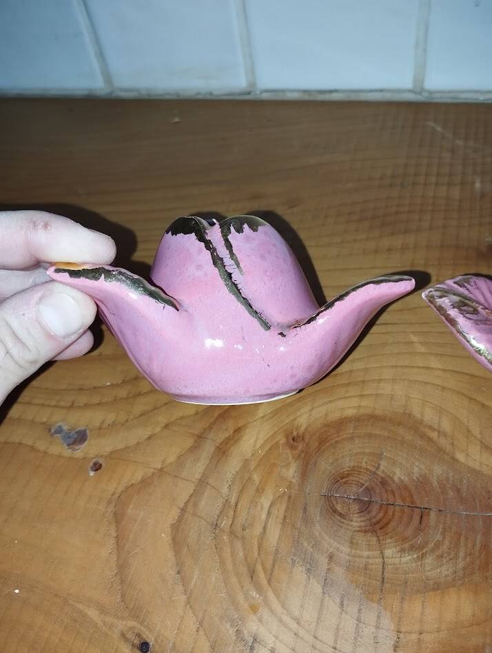 A pair of pink earthenware candlesticks (1940s–50s)