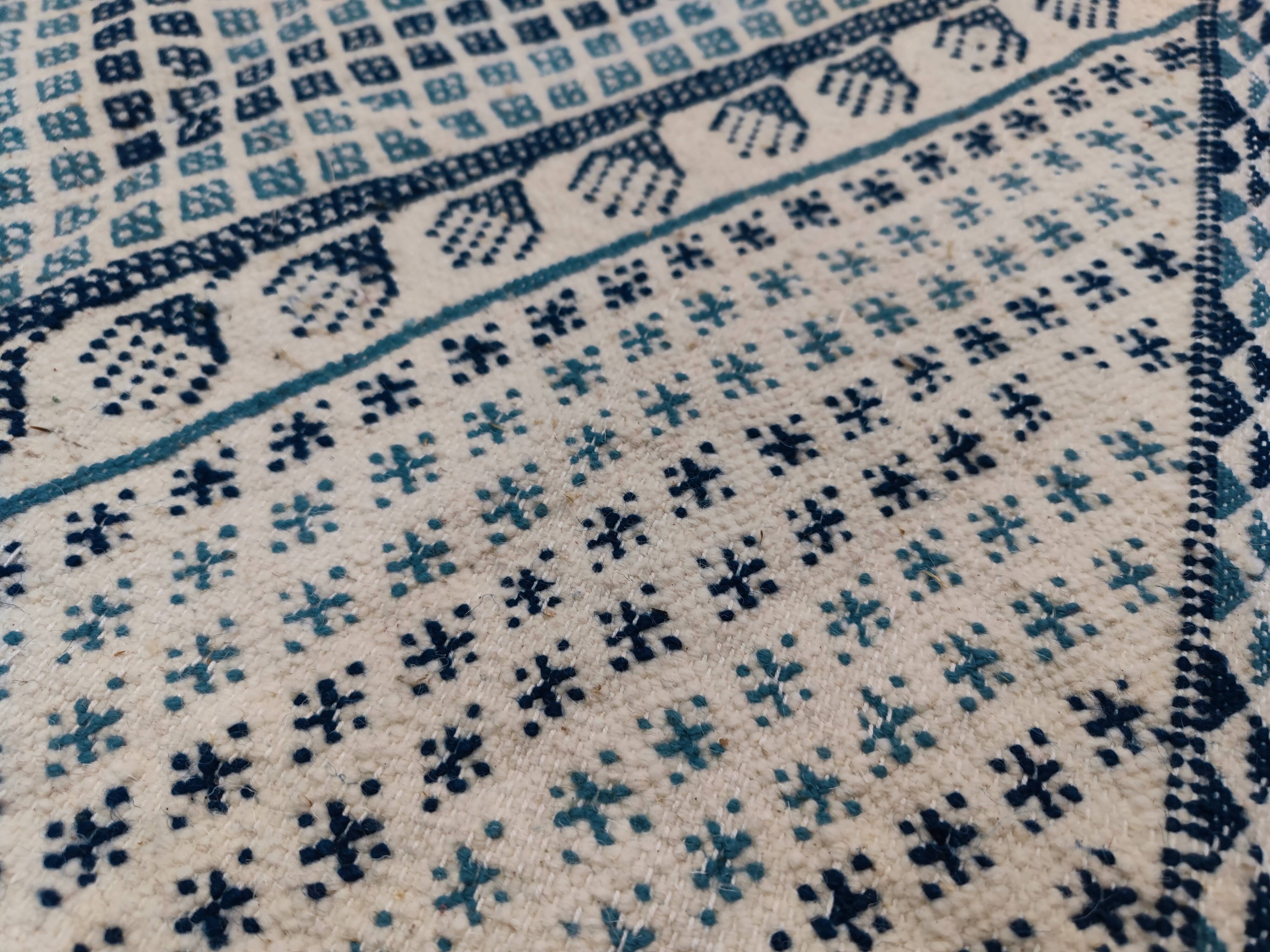 White and blue handwoven rug in natural wool
