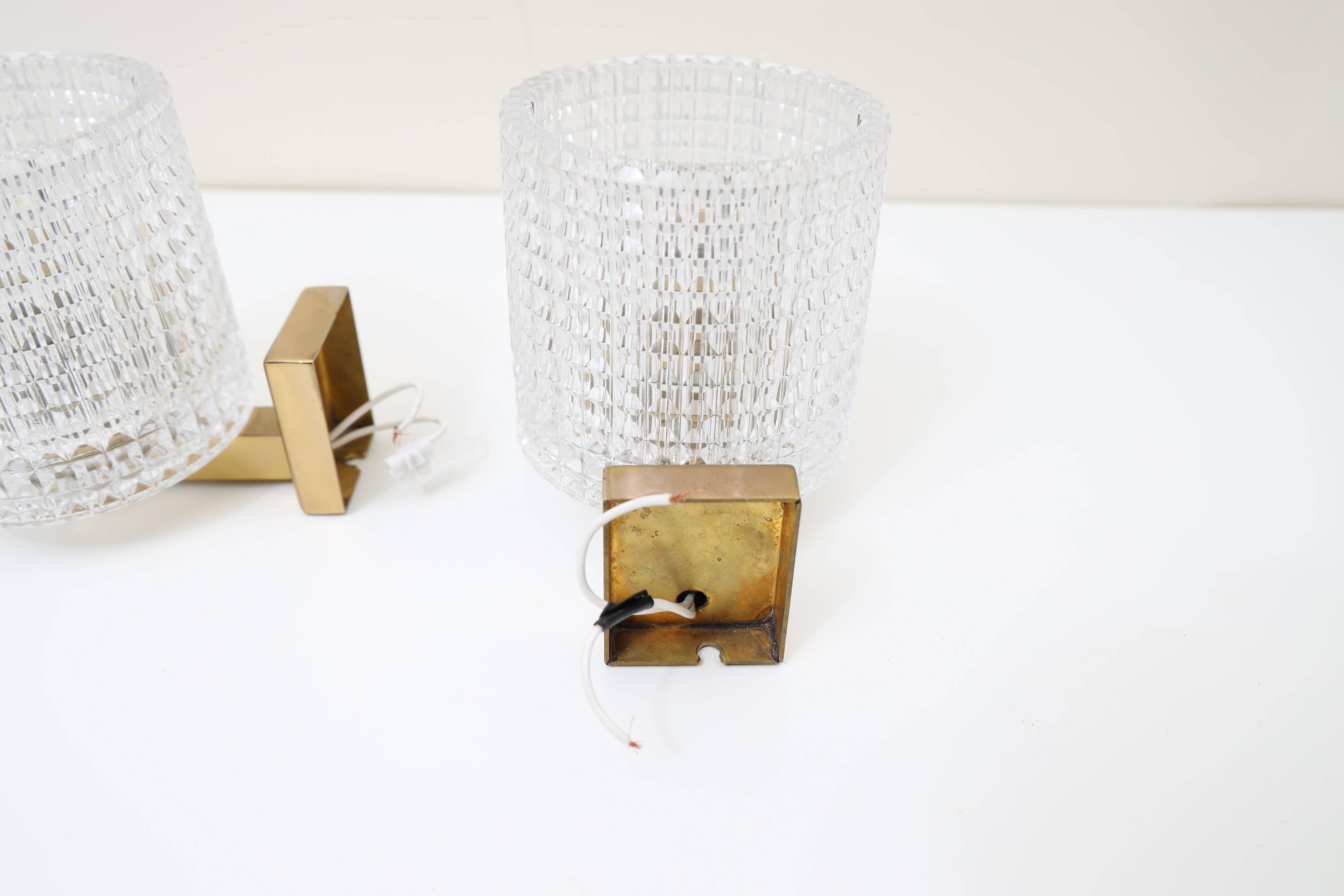 Carl Fagerlund for Orrefors Pair of wall lights in brass and glass Sweden 1960