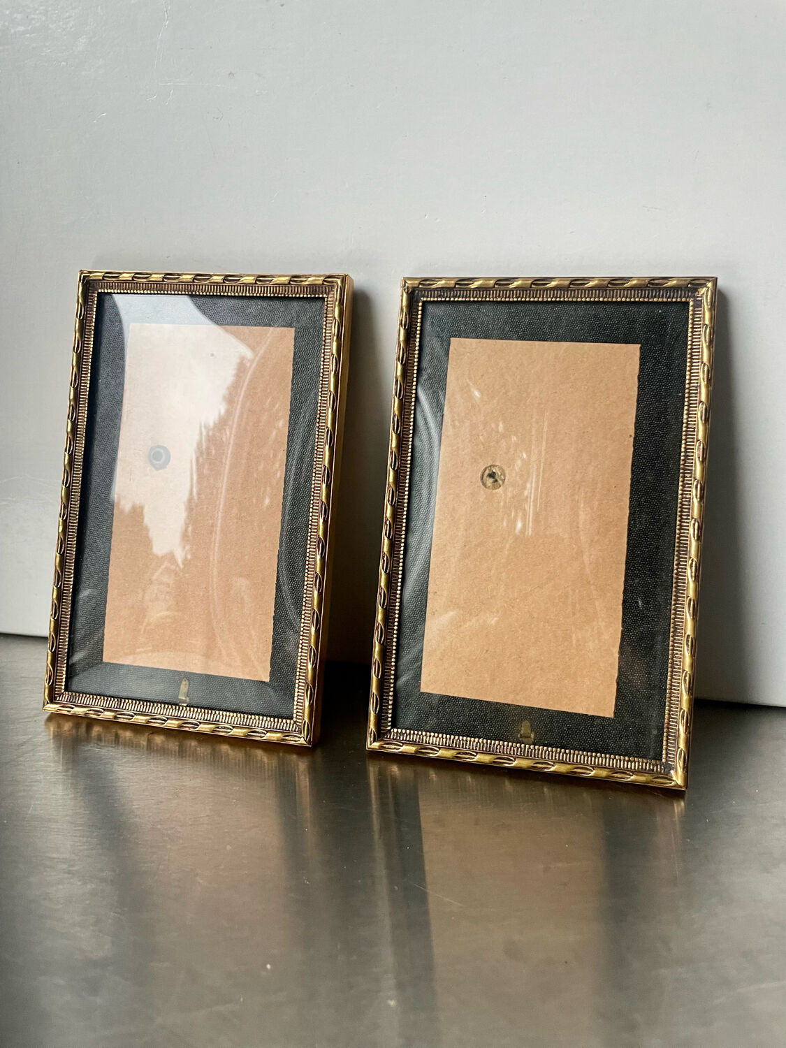 Pair of identical gold colored metal frames each measures  14.5 cm x 9 cm convex glass