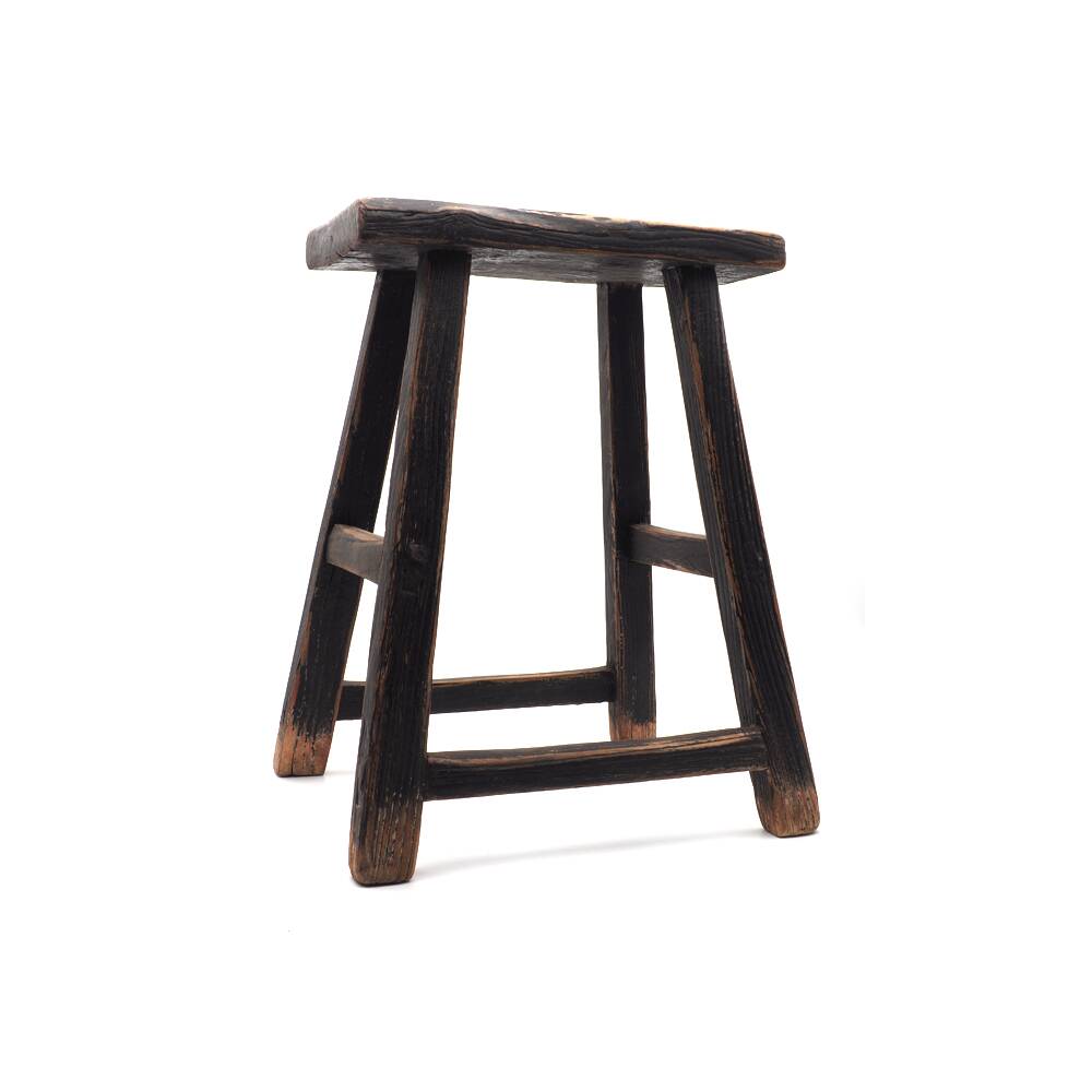 Rectangular stool in raw black elm.
