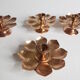 Set of four copper candlesticks in the shape of lotus flowers