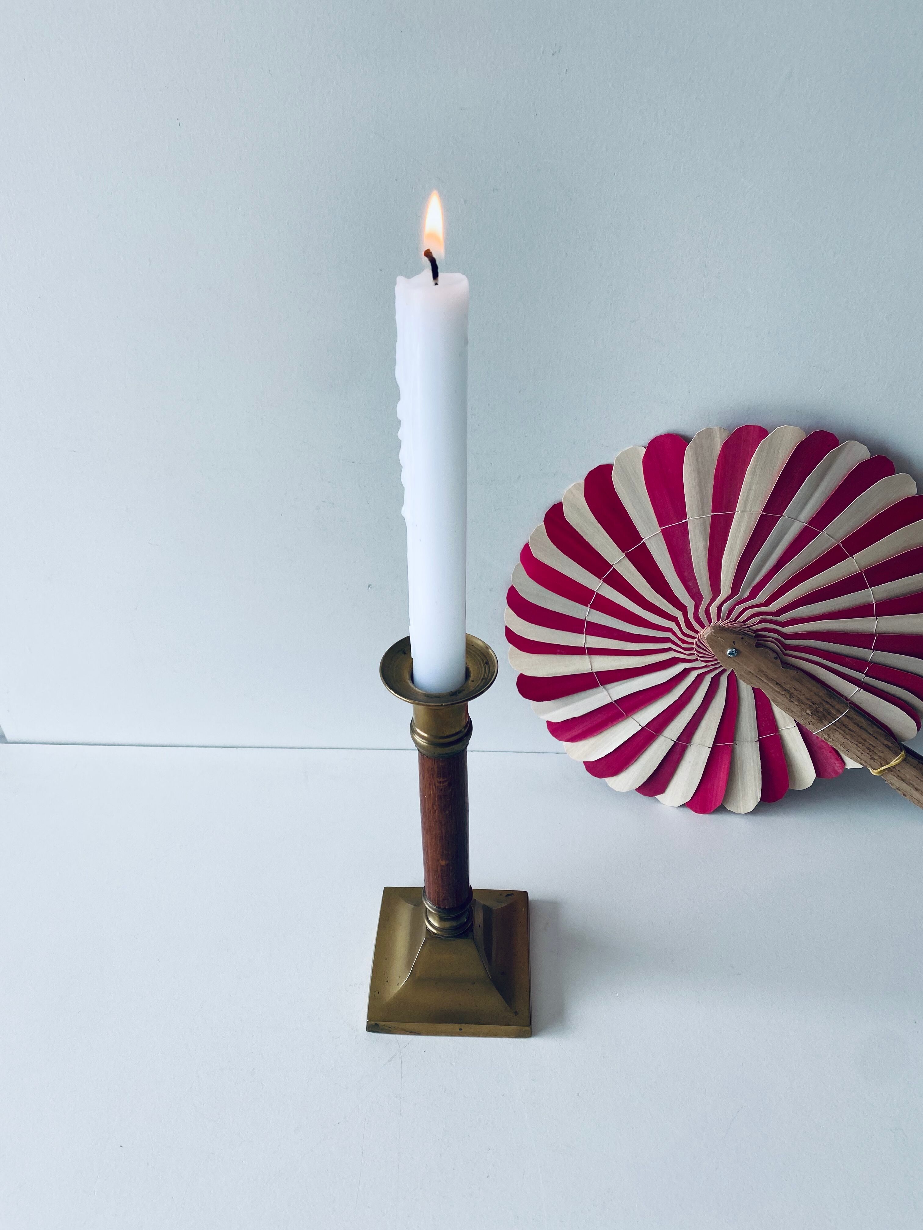 Old candle holder in brass and wood
