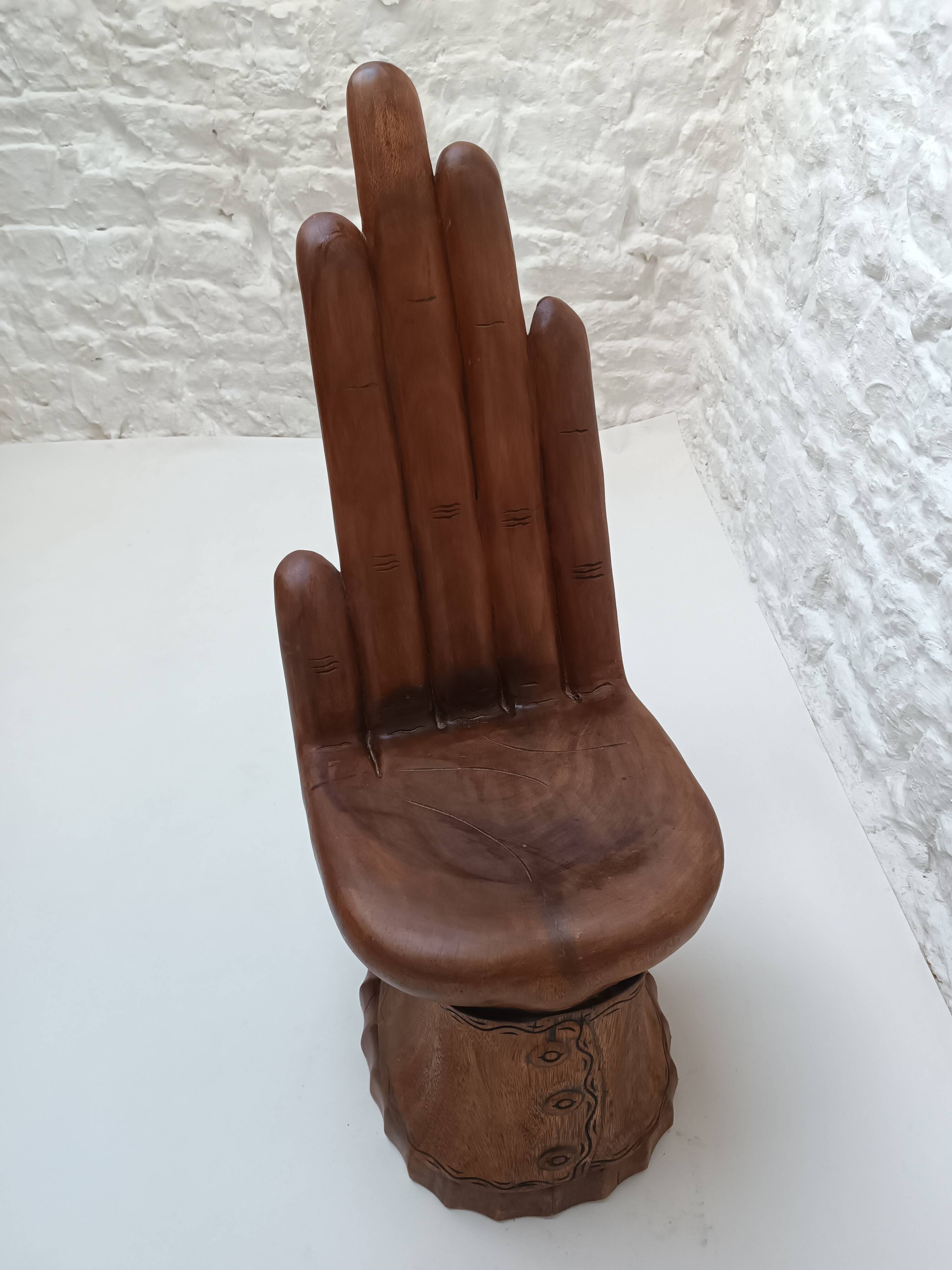 Sculpted wooden chair in the shape of a hand, 1960.