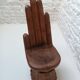 Sculpted wooden chair in the shape of a hand, 1960.