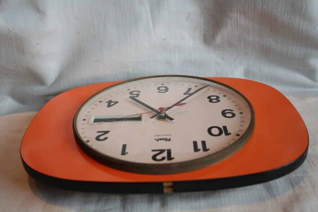 Vintage wall clock in orange formica