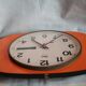 Vintage wall clock in orange formica