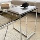 Set of 2 vintage nesting coffee tables in chrome metal and smoked glass.