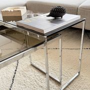 Set of 2 vintage nesting coffee tables in chrome metal and smoked glass.