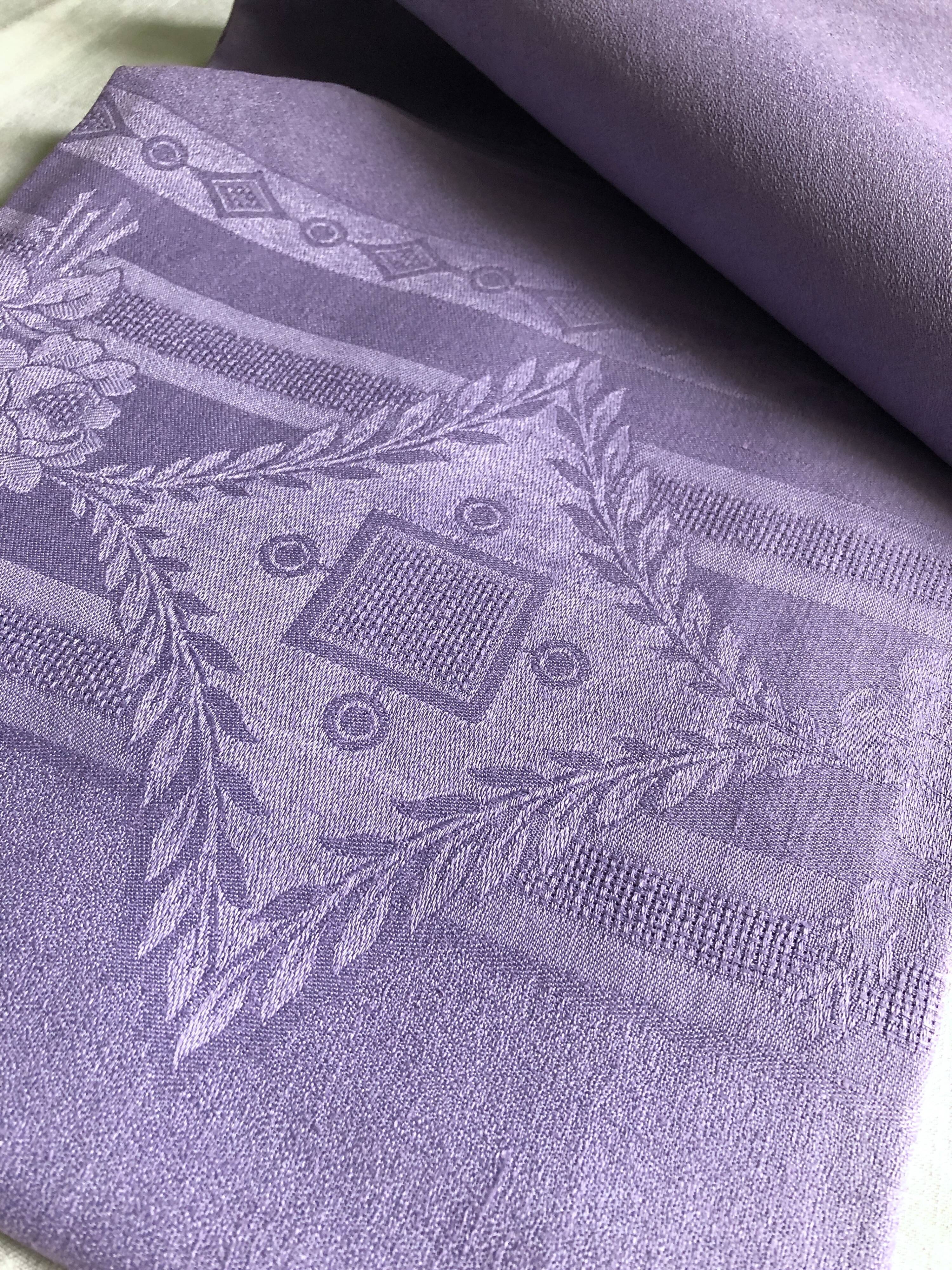 Old damask tablecloth in linen and purple silk