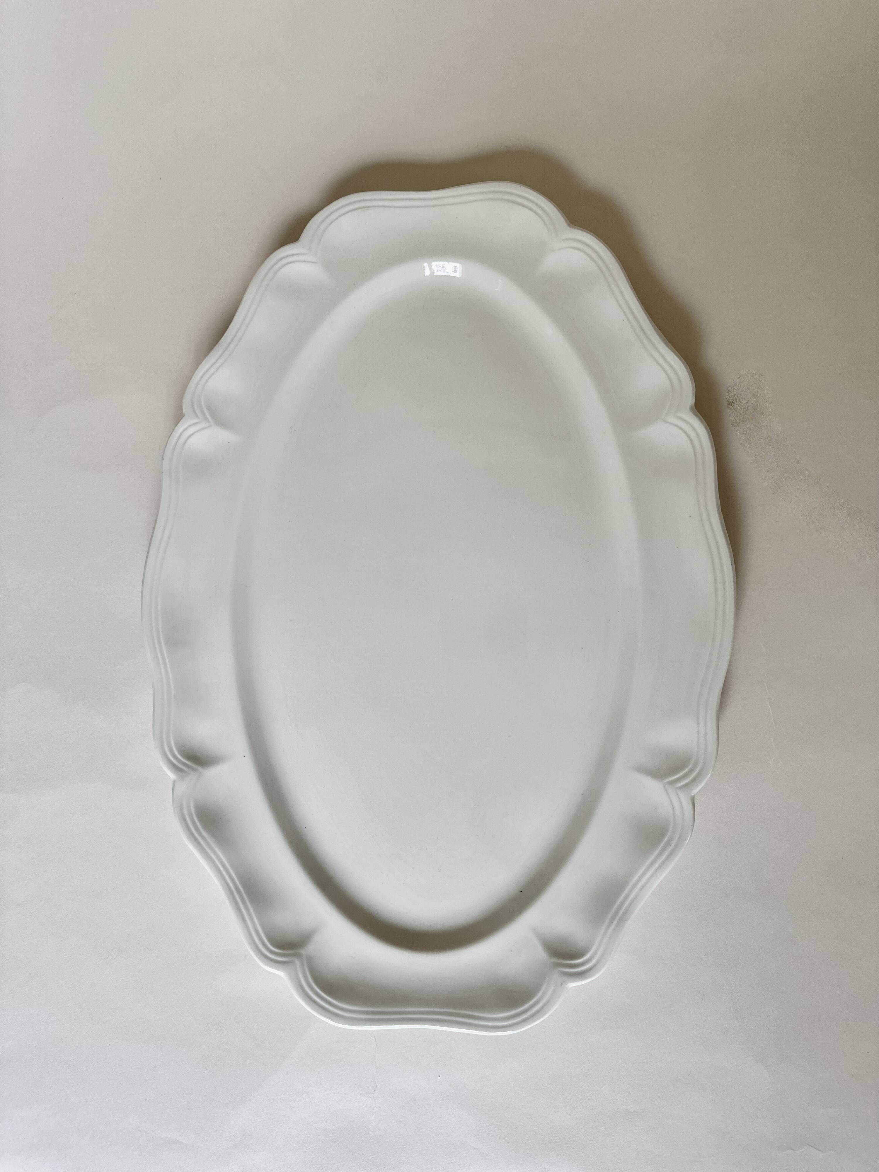 Shaped plates and dishes in Sarreguemines earthenware.