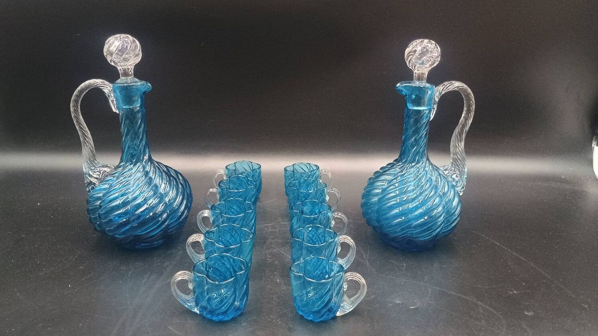 Cabaret Portieux liqueur service with 10 blue and clear glasses.