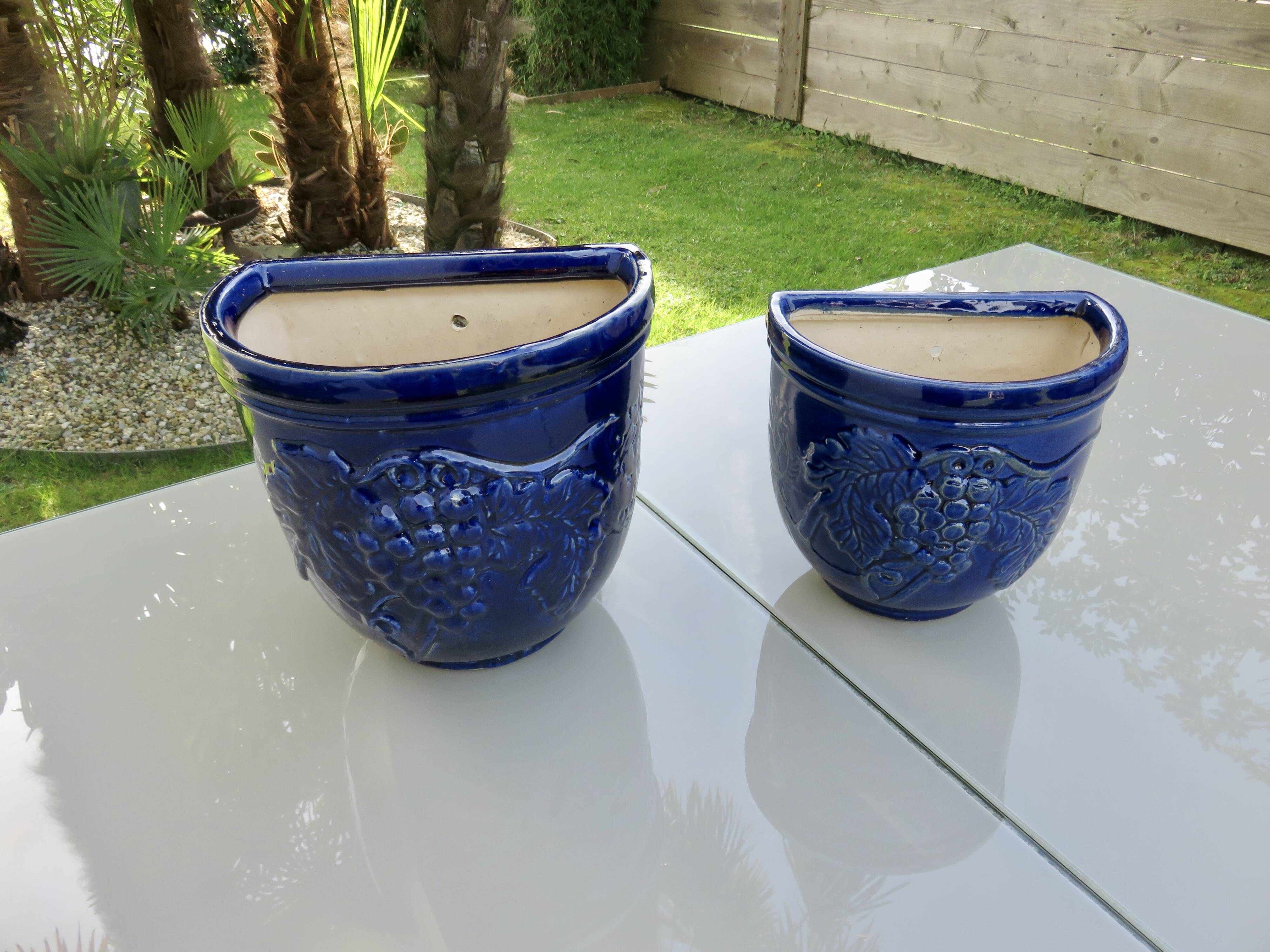 Wall pot in glazed blue terracotta with a grape motif, 1970s.
