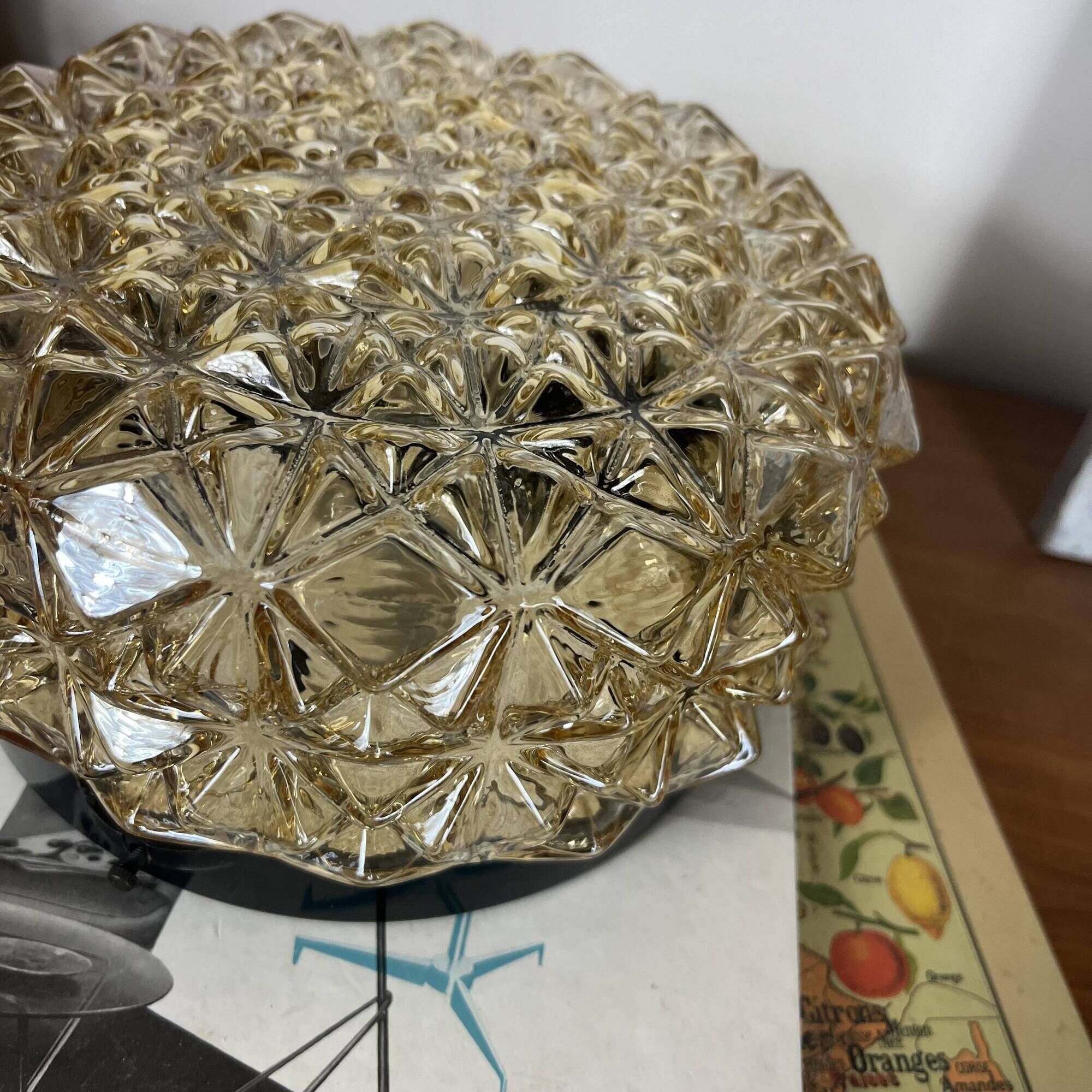 Vintage 1970s round wall light ceiling fixture with amber glass and gold.