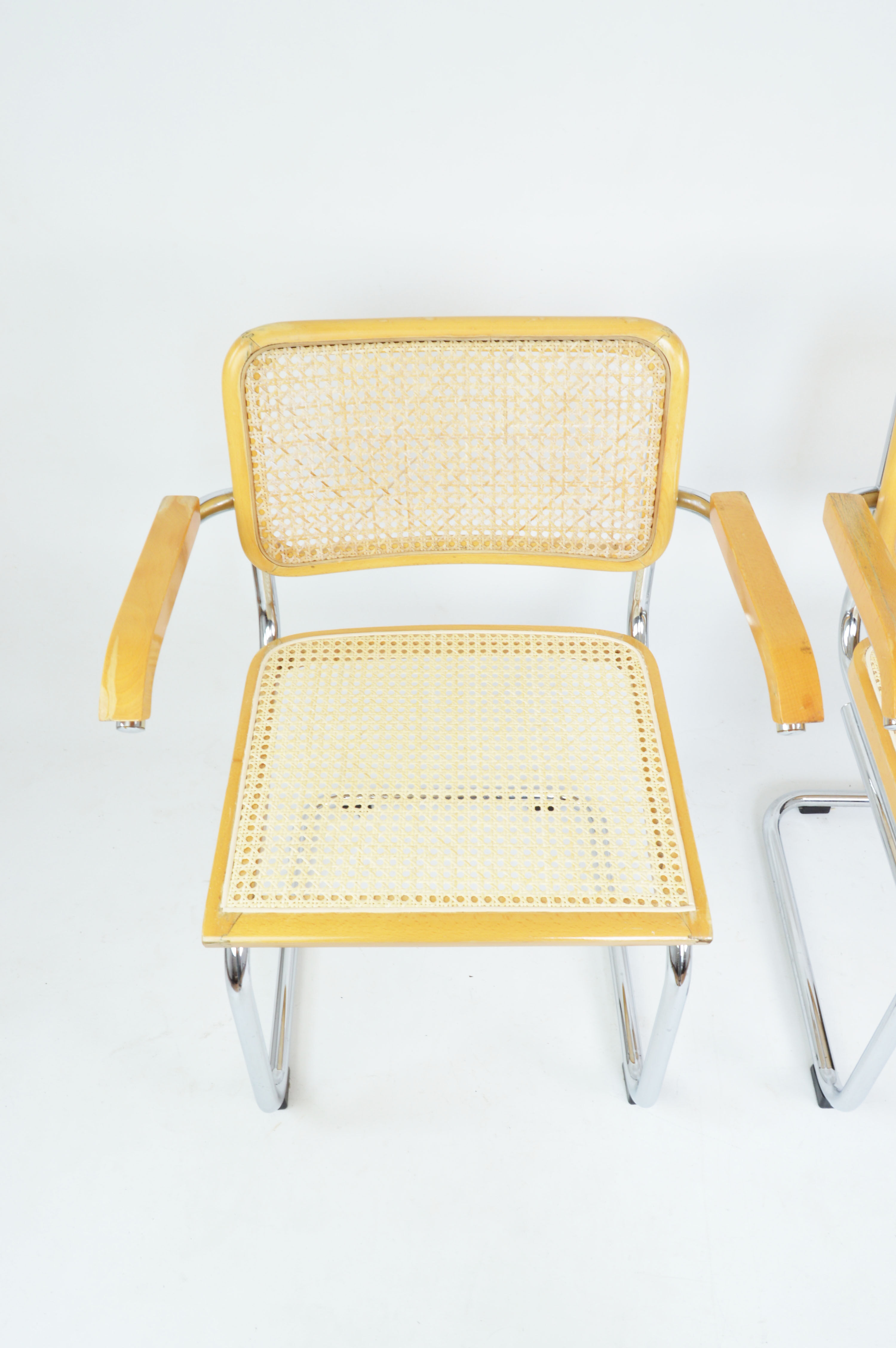 A pair of chairs with armrests, 1970s