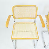 A pair of chairs with armrests, 1970s