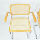 A pair of chairs with armrests, 1970s